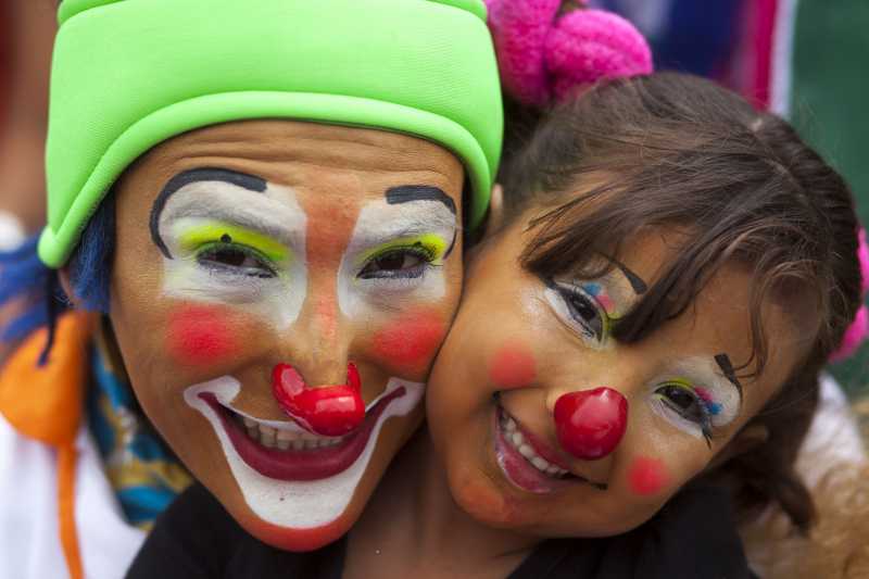 Clowns pose for photos during the sixth Latin American Congress of Clowns parade, at the Historical Center of Guatemala City, capital of Guatemala
