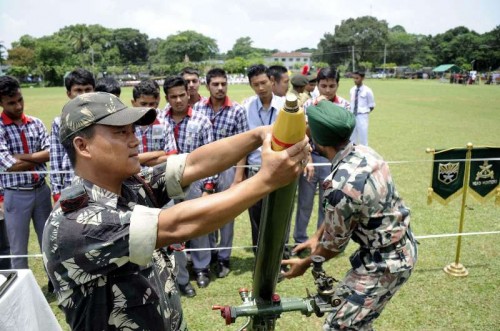 An Indian army personnel demonstrates how to operate mortars to school students during `Know Your Army`- a programme organised by Indian Army at Assam Rifles ground in Agartala.