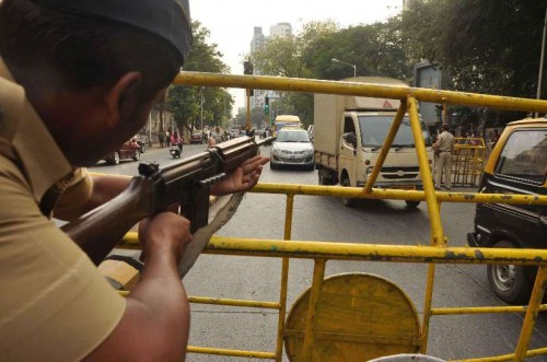 A policeman on high alert in the wake of a terror attack on a school in Pakistan's Peshawar city in which over 100 students were killed in Mumbai, on Dec 17, 2014. 