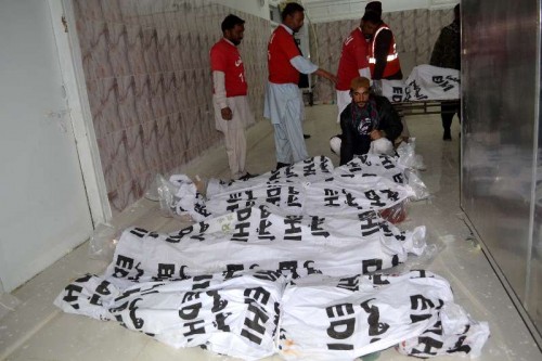 Pakistani security personnel identify the bodies of militants killed at a hospital in southwest Pakistan's Quetta.