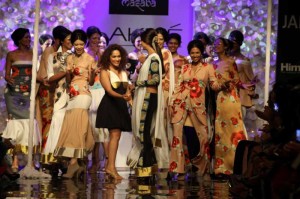 Fashion designer Masaba Gupta walk with Bollywood actor Shilpa Shetty during her show at the Lakme Fashion Week (LFW) Winter/ Festive 2014 in Mumbai, on Aug. 20, 2014. (Photo: IANS)