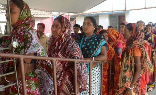 Voters waits for casting their vote at the polling station Basirhut during Basirhut South Assembly bypolls in West Bengal on Sept 13, 2014. (Photo: IANS)