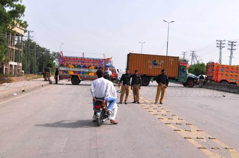  Policemen stop vehicles on the way to Islamabad airport in Rawalpindi, Pakistan, June 23, 2014. Pakistani authorities on Monday denied permission to a plane carrying an anti-government religious leader to land at Islamabad airport over security concerns