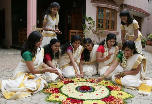 Women decorating Rangoli with flowers, on the eve of Onam Festival, in Bangalore