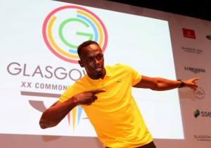 Usain Bolt of Jamaica poses for aphoto during a press conference on day 3 of the Glasgow 2014 Commonwealth Games