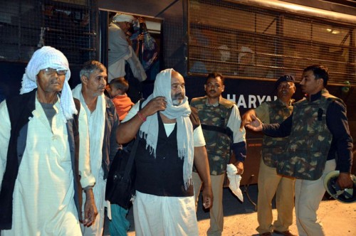 Followers of controversial sect leader Rampal come out of Satlok Ashram near Barwala town in Haryana's Hisar district, 210 km from Chandigarh on Nov 19, 2014. 