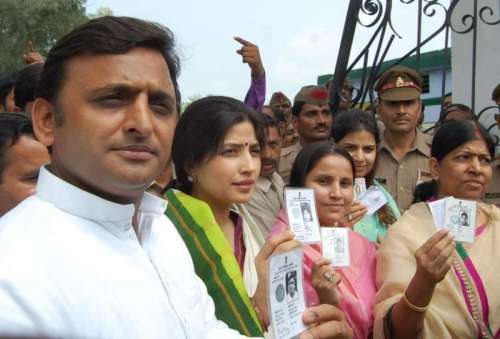 UP Chief Minister Akhilesh Yadav with wife and MP Dimple Yadav showing their voter Id during Lok Sabha by-poll in Mainpuri, Uttar Pradesh 