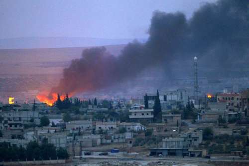 Smoke rises after an US airstrike on positions of Islamic State (IS) terror group in Kobani, Syria, on Oct. 15, 2014. The airstrikes initiated by a US-led coalition against IS continued in the southtern part of Syrian border city of Kobane