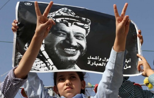  Palestinian school girls hold a poster of the late Palestinian leader Yasser Arafat on the 10th anniversary of Arafat's death in the West Bank city of Jenin on Nov. 11, 2014. Arafat died in Paris on Nov. 11, 2004 at the age of 75 after falling sick a month earlier.