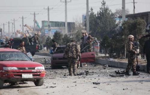 Afghan security forces inspect the site of suicide bombing in Kabul, Afghanistan, Nov. 27, 2014. At least five Afghan civilians were killed and 34 others wounded Thursday morning after a suicide car bombing targeted a British embassy armored vehicle in eastern of Afghan capital of Kabul, sources said. 