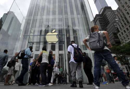  People walk by the Apple Store on 5th Avenue in New York