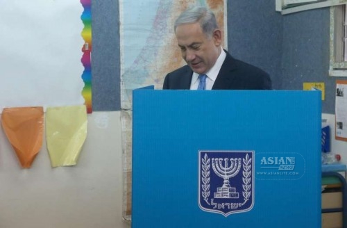 Israeli Prime Minister Benjamin Netanyahu fills in his ballot at a polling station during the parliamentary election in Jerusalem, on March 17, 2015. Israel held parliamentary election