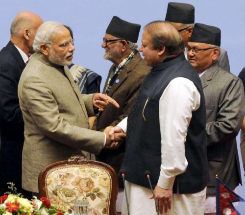 Prime Minister Narendra Modi shakes hands with Prime Minister of Pakistan, Nawaz Sharif at the 18th SAARC Summit, in Nepal on Nov 27, 2014. Also seen Prime Minister of Nepal Sushil Koirala. 