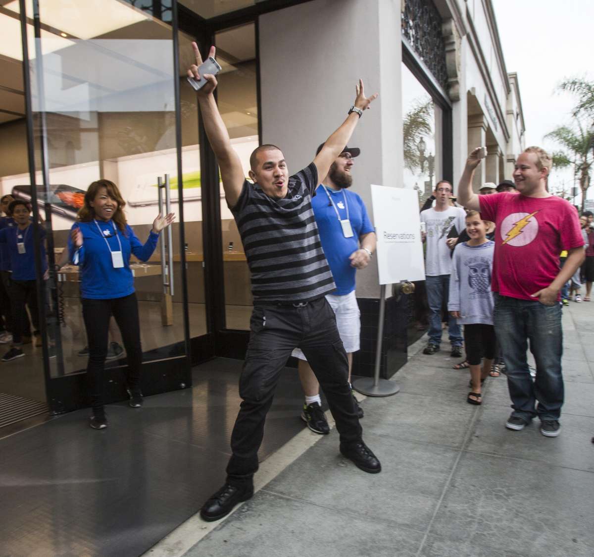 An Apple fan celebrates for being the first person purchasing an iphone 6 smartphone at an Apple store in Los Angeles, California