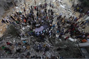 Palestinians try to find survivors under the debris of a destroyed house in Al Sheikh Redwan area in the Gaza City. A large-scale Israeli military operation launched on the Gaza Strip since July 8 has already killed a total of 548 Palestinians and wounded around 3,300 others, medics said on Monday. 