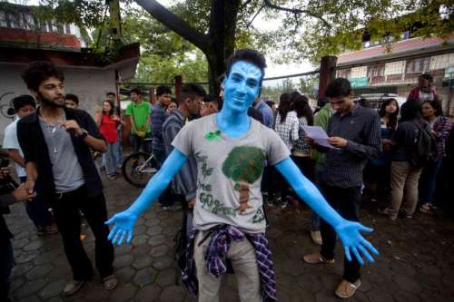  A Nepalese youth painted in blue participates in the people's climate march in Kathmandu, Nepal