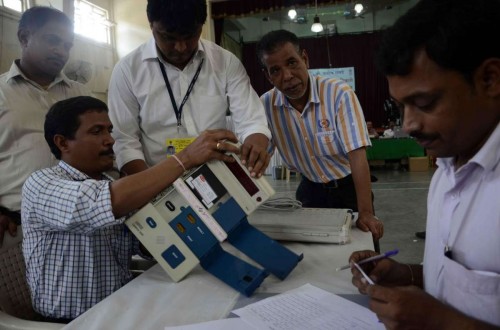 Polling personnel inspect Electronic Voting Machines ahead of Maharashtra Assembly polls in Mumbai, on Oct.8, 2014. (Photo: Sandeep Mahankal/IANS)