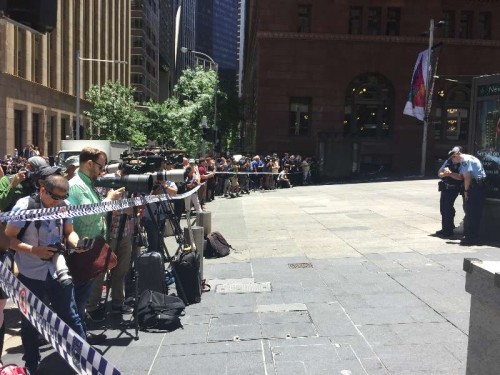 Policemen guard at the cafe where armed men took up to 40 hostages in Sydney, Australia, on Dec. 15, 2014. Police closed down central Sydney on Monday after armed men took up to 40 hostages at a busy cafe.