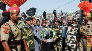 Pakistan Rangers Director General Major General Khan Tahir Javed Khan offers sweets to Border Security Force (BSF) Deputy Inspector General (DIG), M F Farooqui on Pakistani Independence Day at Indo-Pakistan border in Wagha of Punjab on Aug 14.