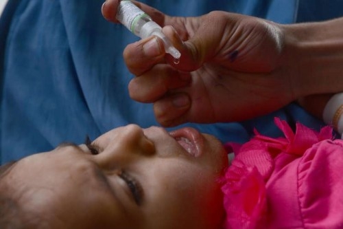  A child is received a polio vaccine during a vaccination campaign in Pakistan