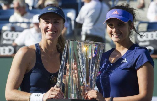 Martina Hingis (left) and Sania Mirza with the BNP Paribas Cup trophy at the awards ceremony. Martina Hingis and Sania Mirza won a 2-0 victory over Russia's Elena Vesnina and Ekaternia Makarova at the Indian Wells BNP Paribas Open women's doubles final on March 21, 2015.