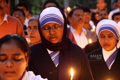 Nuns hold a candlelight vigil to condemn the recent attack on an under-construction church in Haryana and the gang rape of a nun in Ranaghat of West Bengal's Nadia district, in New Delhi, on March 16, 2015