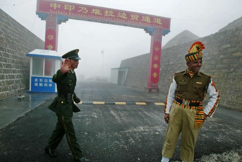 In this photograph taken on July 10, 2008, a Chinese soldier (L) and an Indian soldier stand guard at the Chinese side of the ancient Nathu La border crossing between India and China. India's foreign minister announced plans on April 25, 2013, to visit China amid a border dispute, saying both countries had a mutual interest in not allowing it to "destroy" long-term progress in ties. According to officials in New Delhi, a platoon of Chinese troops set up a camp inside Indian territory on April 15, 2013. India has since called on the Chinese soldiers to withdraw, but several meetings between local army commanders and diplomats from both sides have failed to resolve the stand-off