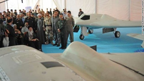 In this picture released by the official website of the office of the Iranian supreme leader, Supreme Leader Ayatollah Ali Khamenei, seated left, listens to an official during his visit at an aerospace exhibition in Tehran, Iran, Sunday, May 11, 2014. The exhibition revealed an advanced CIA spy drone, front, captured in 2011 by Iran, and its Iranian-made copy, back. Khamenei, during the exhibition Sunday, criticized the West for its demands Tehran restrict its missile power, the official IRNA news agency reported.