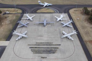 In this photo released by Australian Defence Department, personnel and multinational aircrafts involved in the search of MH370 in Southern Indian Ocean pose for photos in RAAF Base Pearce, Australia. 