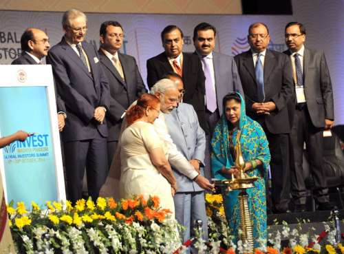 The Prime Minister, Shri Narendra Modi lighting the lamp to inaugurate the "Invest Madhya Pradesh - Global Investors Summit 2014", at Indore, Madhya Pradesh on October 09, 2014. The Speaker, Lok Sabha, Smt. Sumitra Mahajan and other dignitaries are also seen.