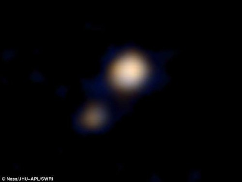 New Horizons spacecraft returns its first colour photos of Pluto (center) and its largest moon, Charon (lower left).