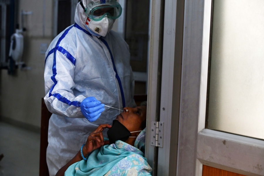 New Delhi: A health worker collects swab samples for COVID-19 testing at a sample collection center set up at a Government school in South Delhi, on July 11, 2020. (Photo: IANS) by . 