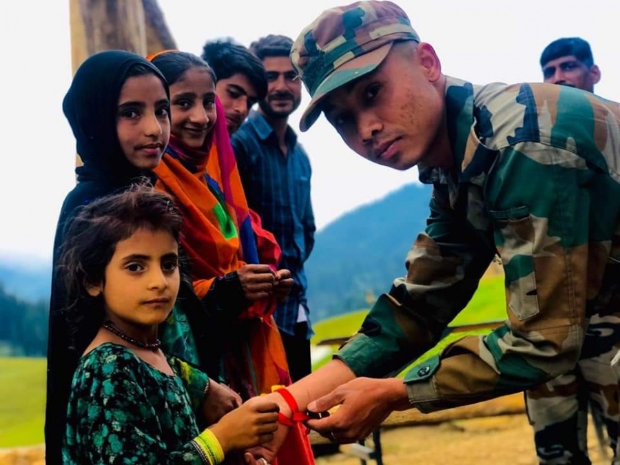 Kupwara: Girls tie rakhis on the wrists of an army personnel in Jammu and Kashmir's Kupwara district on the occasion of Raksha Bandhan on Aug 3, 2020. (Photo: IANS) by . 