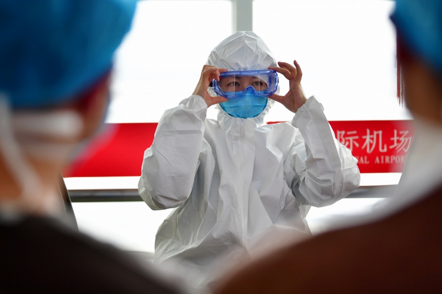 LANZHOU, Jan. 28, 2020 (Xinhua) -- Xu Xiaoyan (C), a head nurse from a hospital affiliated to Gansu University of Chinese Medicine, shows how to wear protective devices for the members of a medical team before their departure for Wuhan of Hubei Province, in Lanzhou, northwest China's Gansu Province, Jan. 28, 2020. A medical team comprised of 137 medical workers from Gansu left for Wuhan on Tuesday to aid the novel coronavirus control efforts there. (Xinhua/Chen Bin) by . 